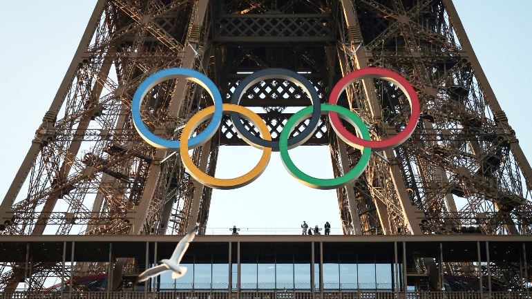 Olympic rings on display at the Eiffel Tower 50 days before the start of the Games